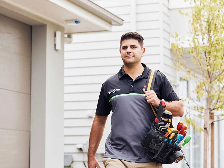 An electrician wearing a PDL Wiser branded shirt.