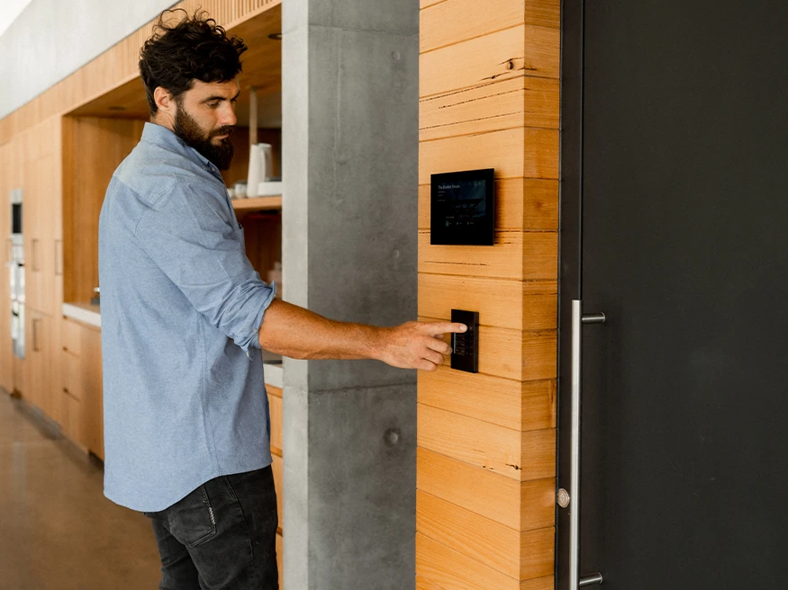 Neil uses a C-Bus touchscreen wall plate installed in Bunker House.