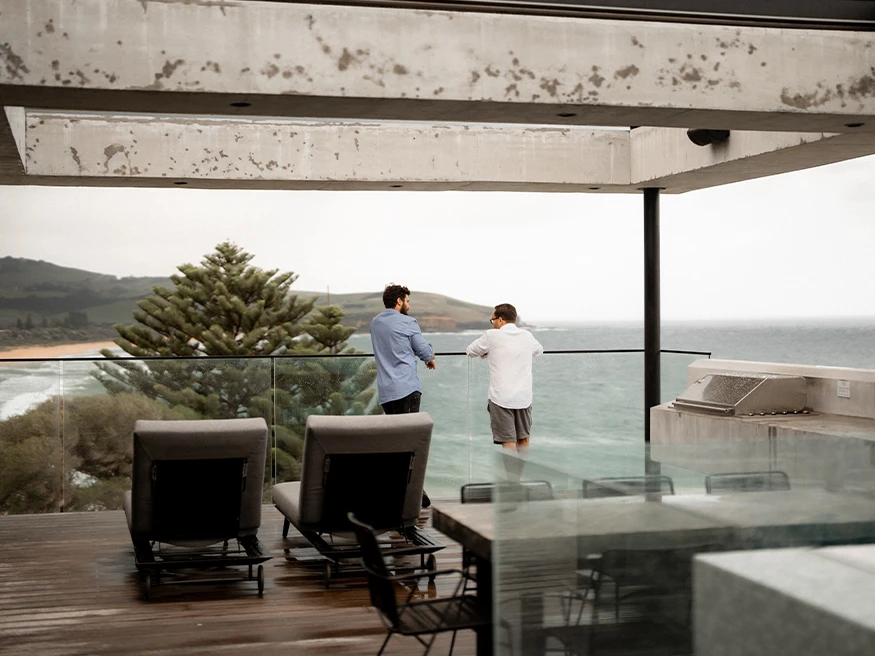 Neil and Tom looking out the oceanfront balcony of Bunker House.