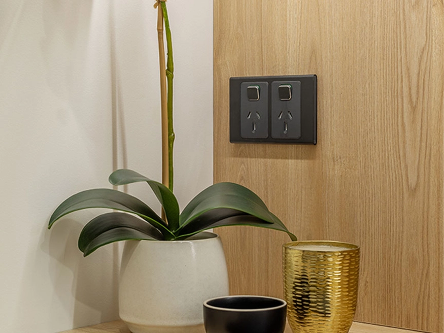 A PDL Iconic Styl socket installed against a wooden backdrop.