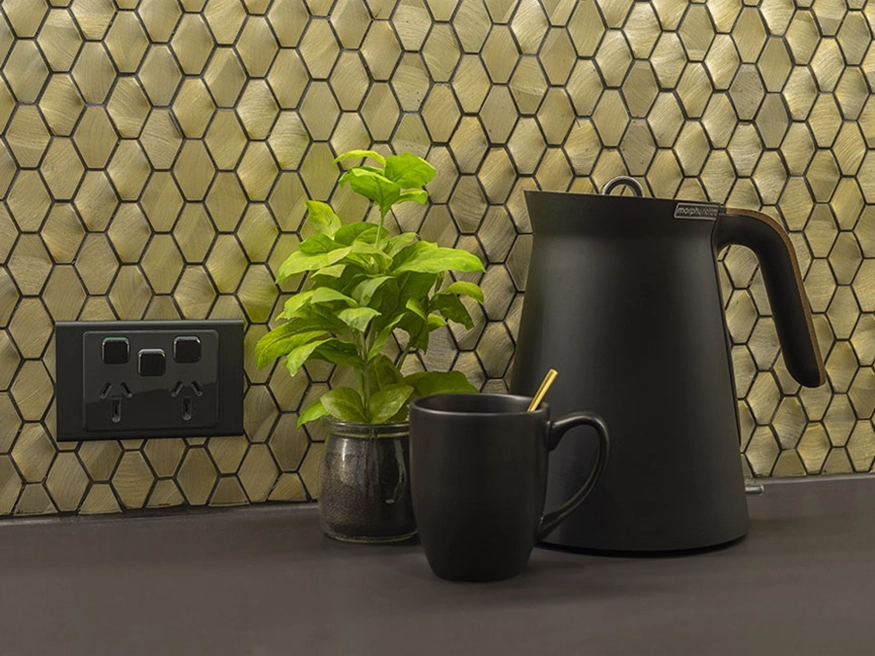 A PDL Iconic socket in Silver Shadow installed against the kitchen scullery’s hexagonal tiles.