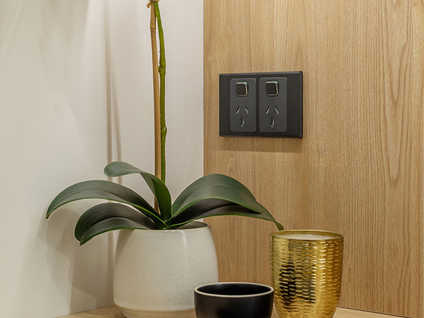 A PDL Iconic Styl socket installed against a wooden backdrop.