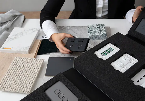 Alt text: A designer chooses from an assortment of PDL Iconic switches.