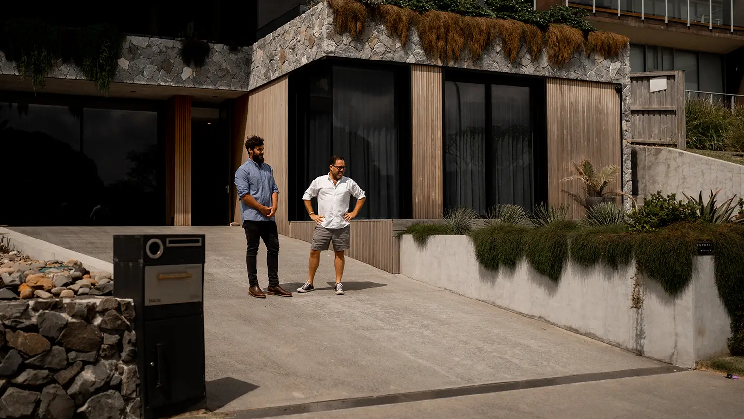 Futureflip director Neil Hipwell and Tom Ryan of Ryelec Automation & Energy standing in the Bunker House’s driveway.