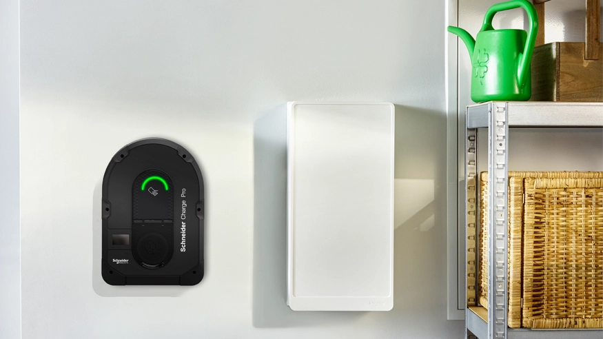 A Schneider Charge Pro EV charger wall-mounted in a garage.