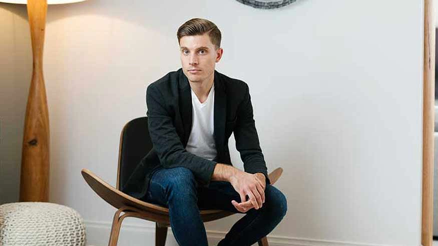 Schneider Electric Design Director TIm Rochford sitting on a chair facing the camera.