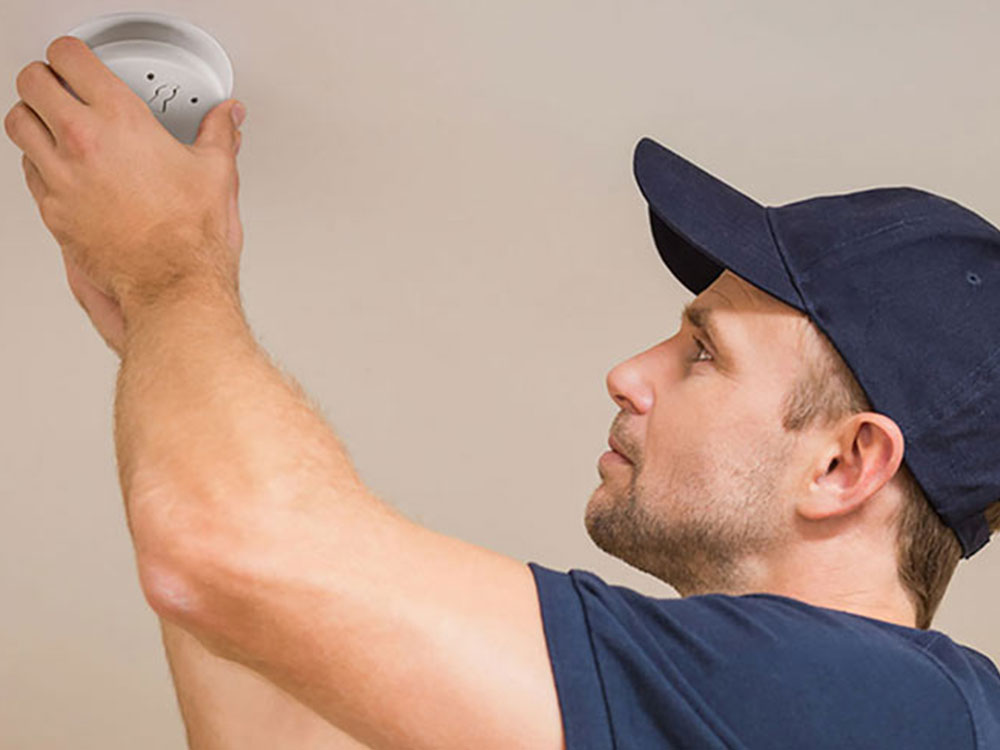 Electrician installing PDL Fire alarm