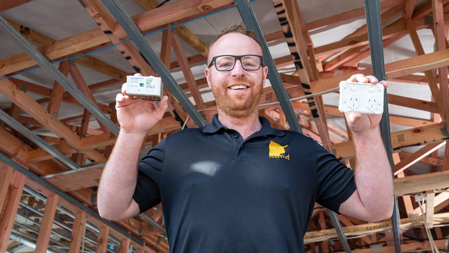 Nathan from Johnston Electrical showing off two PDL Wiser Smart Home products.
