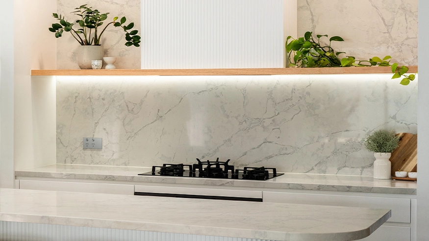 A modern kitchen featuring elegant marble countertops and a clean, minimalist design.