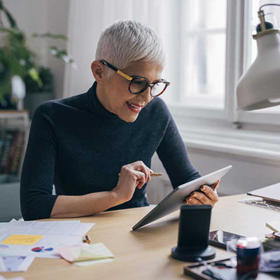 Woman holding an iPad on her left hand