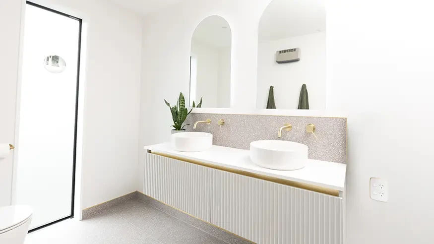 The bathroom in Ben and Quinn’s home, featuring a Wiser Water Leakage sensor.