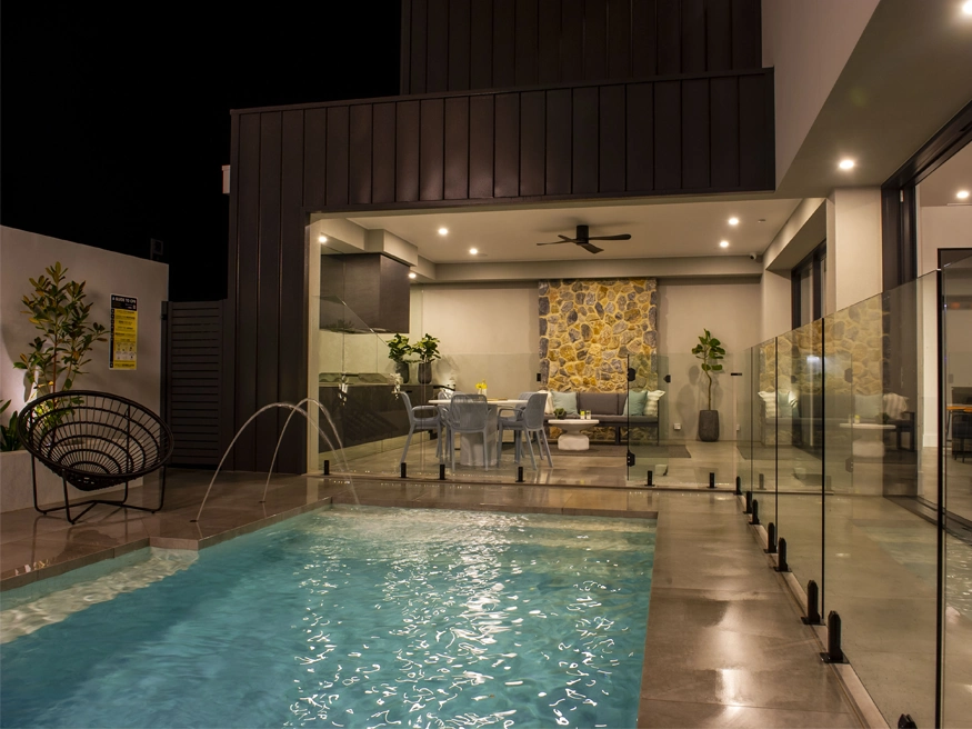A well-lit outdoor poolside area.
