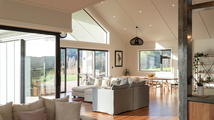 Modern living space featuring large glass sliding doors, with a bright, well-lit and relaxing atmosphere.