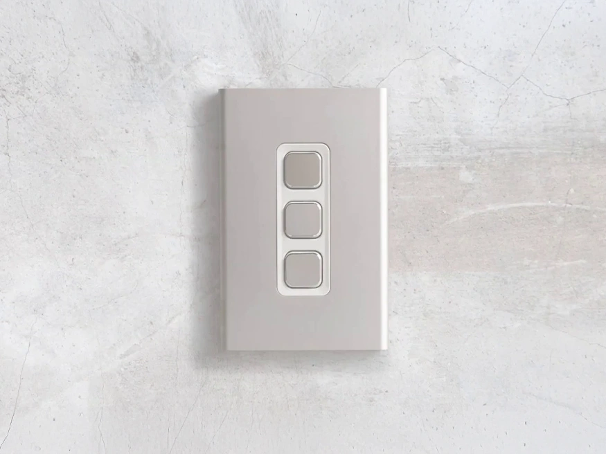 Iconic Styl light switch in Crowne finish with three vertical switch buttons.