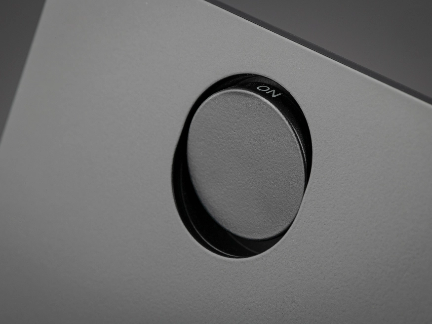 Close up of a Clipsal Solis Matte Black switch's push button, showcasing the detailing in the switch plate.