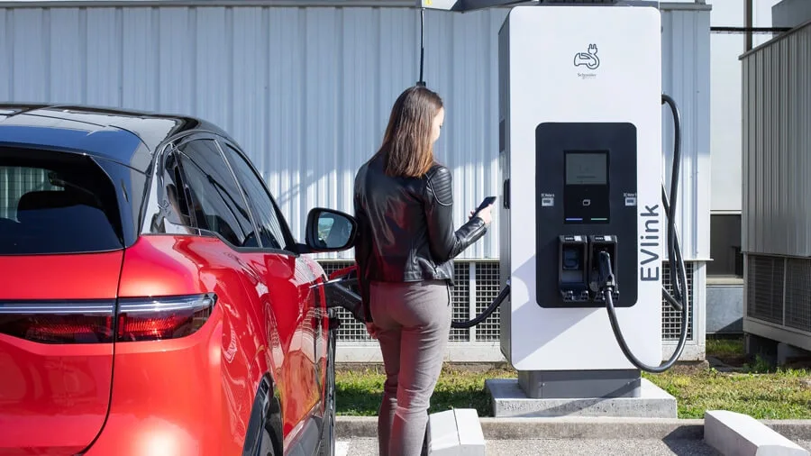 Woman charging car using EV link