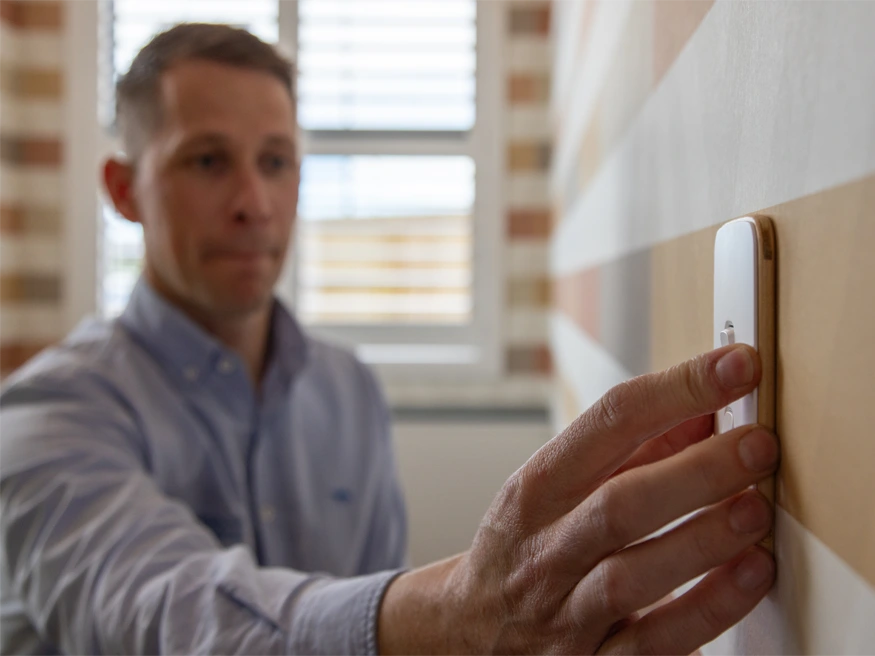 Jared from Christchurch Electrical inspecting a PDL Iconic Essence switch.