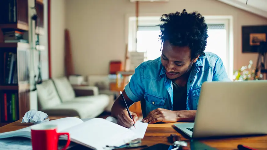 A man registers for a C-Bus training course on his laptop.