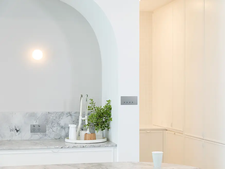 Clipsal Solis switch in Platinum Aluminium finish mounted on a white wall.