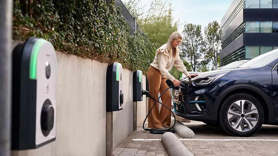 Woman charging her electric vehicle