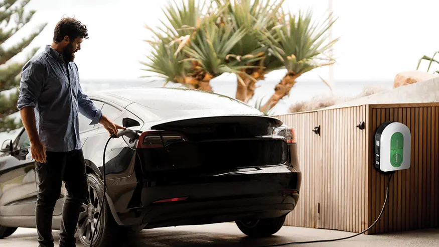A homeowner charges his car using a PDL Electric Vehicle (EV) Charger.