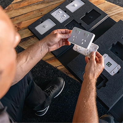 An electrician inspects a PDL Iconic socket.