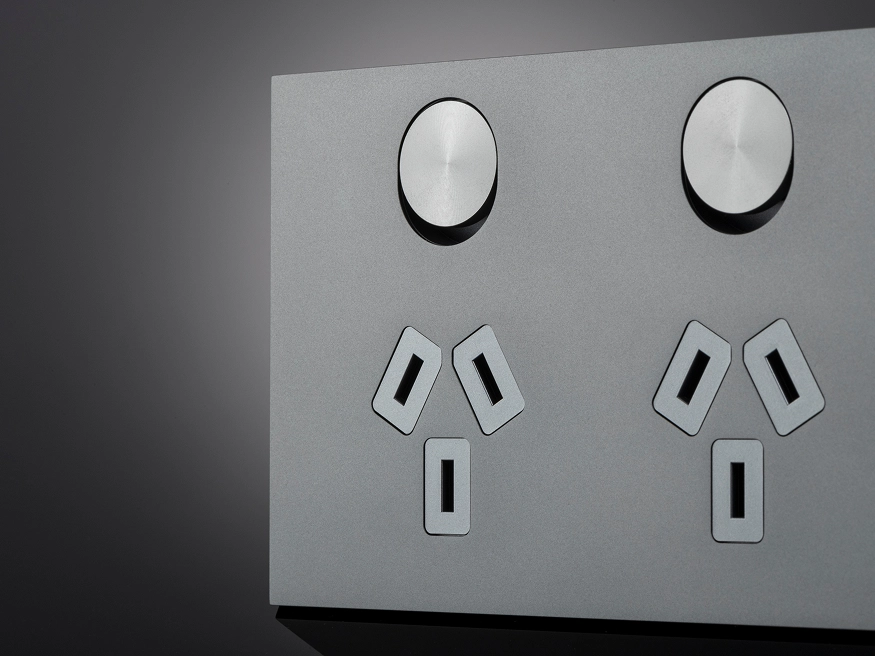 A close up of a Clipsal Solis T Series Ebony Aluminum power outlet.