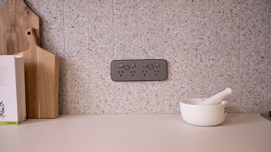 Iconic Essence on a speckled kitchen splashback beside a mortar and pestle.