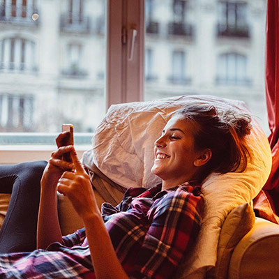 Lady on couch with smart phone